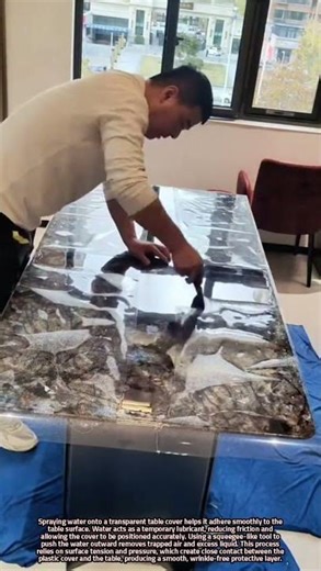Applying a Transparent Table Cover Using Water and a Squeegee Tool