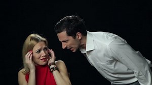 Man furiously yelling at a woman while she is crying. High definition video.