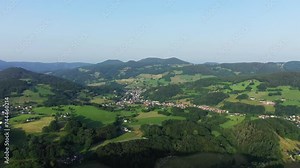 The green Alsatian countryside among forests and mountains overlooked by a rock , in Europe, France, Alsace, Bas Rhin, towards Strasbourg, in summer, on a sunny day.