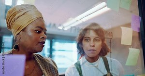 Sticky notes, planning and team writing on a board while analyzing research for a creative project. Collaboration, teamwork and female marketing employees working on advertising strategy in an office