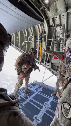 This group of soldiers was jumping out of a military aircraft with the door wide open high above the ground. They were stepping off the ramp one by one into freefall with their parachutes ready while the rest of the team watched from inside.They look completely calm and professional as they leap out over the clouds and countryside below. I give them props for making it look so easy up there, would you ever jump out of a plane like that?