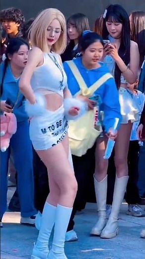 blonde bombshell is dancing wildly in the street; her figure and looks are absolutely stunning!
