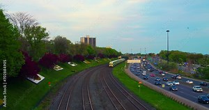 Train on railroad parallel to bustling highway aerial view Life thrives where railroad meets road constant movement. Railroad and highway dual veins of transportation buzzing with activity.