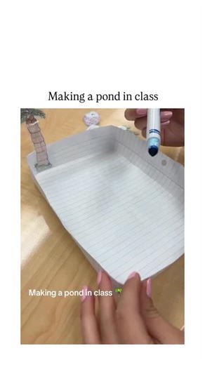decode world on Instagram: "The post features a short video tutorial demonstrating a simple DIY classroom craft: lining a tray with graph paper, drawing water patterns with blue water-soluble markers, adding water to dissolve the ink into a realistic pond effect, and decorating with paper cutouts of fish, turtles, and palm trees. Posted by Indonesian user @sasmayaku on October 29, 2025, it quickly gained traction with over 185,000 views and 768 likes, sparking Indonesian-language replies praisin