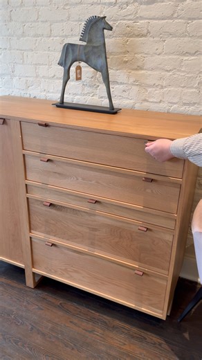 This cabinet checks all the boxes: drawers for storage, a pull-out surface for desk space and a design that’s as functional as it is stylish. It’s a true Farmville find — the kind of piece that makes exploring our showrooms worth the trip. Come discover furniture that works as hard as you do at Green Front Modern in Building 15. What would you tuck away in a piece like this? | Green Front Furniture