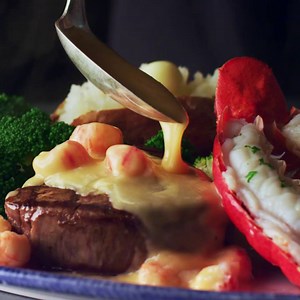 Surf’s up for the New Lobster and Topped Steak – creamy langostino lobster on top of a juicy filet, served with tender steamed lobster. Only at our Ultimate Surf & Turf Event. | Red Lobster