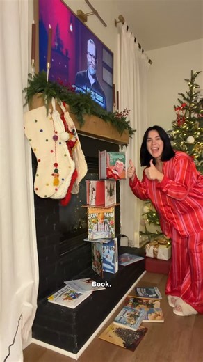 Nina Caviggiola • momhood & midsize style on Instagram: "Elf on the shelf for adhd and ocd friends day 2! Easy, quick, mindless BUT promoting kindness and positive role modeling. I’m always finding ways to make reading more fun so of course it’s part of our journey. Elf is balancing in all of our fave Christmas stories. Comment with your favorite holiday books below I need more for our collection. Also LET ME KNOW what you did for day 2 :) #elfontheshelfideas #elfonashelf"