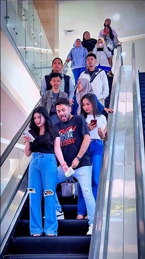 Funny handcuffing beautiful girl prank on escalator