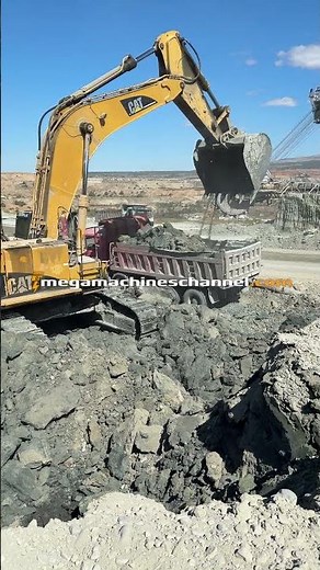 CAT Digger Loading Trucks At Mining Site