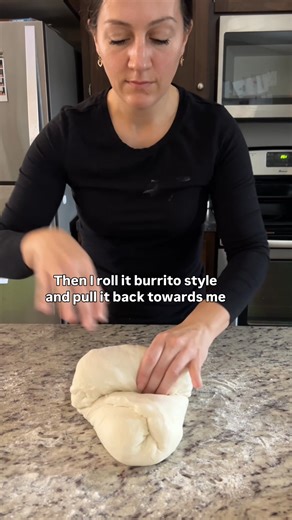 Part two of making your first sourdough loaf with your new starter 💕🎉 Once bulk fermentation is complete, it’s time to shape the dough. Lightly dust a clean work surface with rice flour, then turn the dough out of the bowl. Preshape by gently pushing the dough away from you and pulling it back in, working in a circular motion until it forms a loose ball. Let the dough rest for 30 minutes. This rest allows the gluten to relax, making the final shaping much easier. After the rest, gently stretch