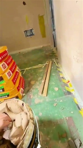 Hand applies plaster ensuring proper wall repair task