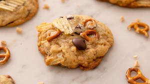 The perfect cookie recipe for cleaning out the pantry, these Kitchen Sink Cookies are full of fun mix-ins. Salty, savory, crunchy, and chewy, these cookies are a delightful treat. | Preppy Kitchen
