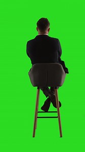 Man Sitting on a Chair in Front of a Green Screen | Free Stock Video Footage
