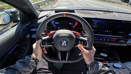 Point of view driving BMW M5 Touring on Autobahn