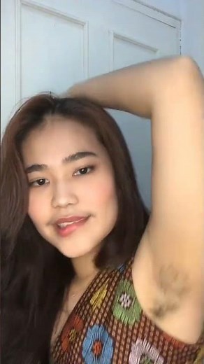 Showing off hairy armpits