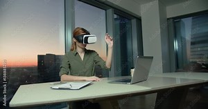 young girl Secretary works in the office using 3D glasses with the VR technology creates a virtual presentation