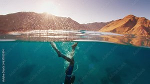 Duck dive freediving. Male freediver does duck dive and freedives in the sea
