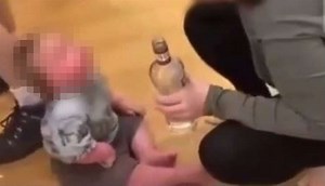 Horror moment toddler is given VODKA in sick video as man and woman arrested