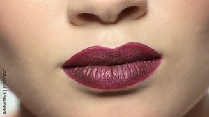 Plump female lips close up. Dark red lipstick. Tips to look sexier.