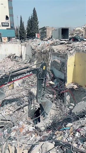 Heavy Machinery Demolishing Building on Construction Site