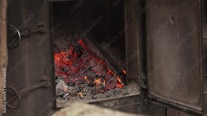 Open wood burning stove. Close-up of oven with open door, front view