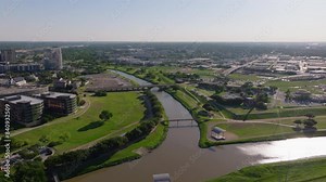 Trinity River in Fort Worth, Texas, from an aerial point of view. Urban landscape, green spaces, and modern architecture in a bright day