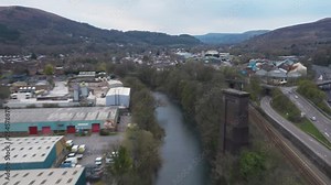 Reverse aerial drone hyperlapse facing north of Taffs Well village passing the historic Walnut Tree Viaduct pillar next to the A470 dual carriageway near Castell Coch revealing Garth hill mountain.