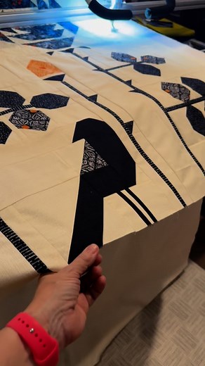 Just finished longarming this beauty! My “Visitor Among the Roses” is a perky black bird who enjoys the giant blooms. I’ve used the Lovely Loops pantograph from Sew Shabby Quilting. I’m wondering, should I leave the pretty lacy loops of stitching on my bird’s body as cream or color in the stitches with a micron marker to make the birds body completely black? What do you think? I’ll share a full image of quilting soon! The Halloween group of Coven will ship next summer. #visitoramongtherosesquilt