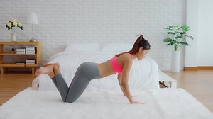 Athletic Healthy Asian woman in sportswear workout excercise at home in bedroom,Young woman with slim body cardio aerobic exercises healthy lifestyle concept