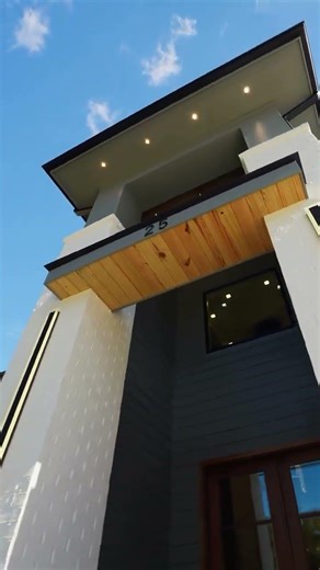 A two-story foyer is one of the most striking design decisions in a home, and this modern build with
