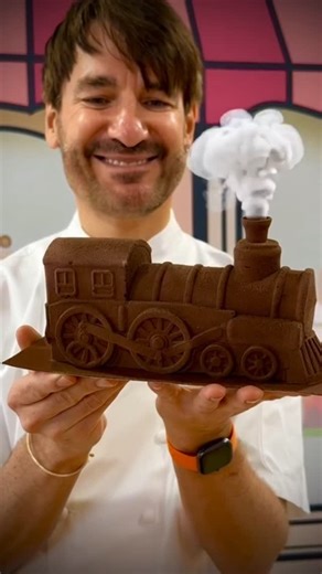 Eric Lanlard on Instagram: "🎄 It’s officially Yule Log season at Cake-Boy! Today we kick off our fully subscribed series of back-to-back Christmas Baking Masterclasses — the kitchen is buzzing, the mixers are singing, and the festive spirit is very much alive! 🧑🏻‍🍳✨ Beyond excited (and proud!) to unveil this year’s show-stopper: our “Polar Express” Bûche de Noël 🚂❄️ A luxurious journey of Valrhona dark chocolate mousse, zesty passion fruit curd, and a Gavotte-style crunchy hazelnut base… pu