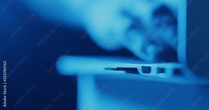 Inserting SD card into memory slot on laptop computer - close up