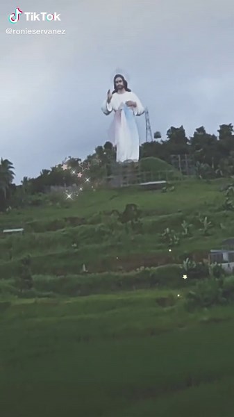 Stunning Religious Statue Overlooking Lush Landscape