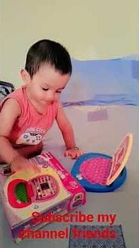 "Adorable Baby Playing with Toy Laptop – Future Tech Genius!"