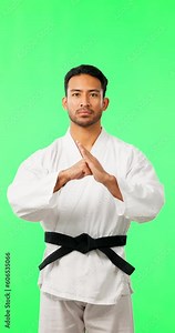 Serious man, karate and greeting on green screen of master with black belt against a studio background. Face of male person or martial arts trainer showing discipline, welcome or respect on mockup