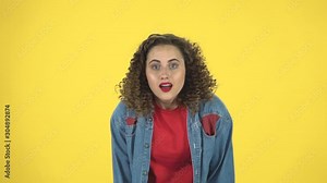 Indignant woman throwing up hands expressing she is innocent, twists his finger at his temple, slow motion