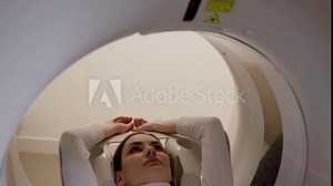 4k video girl patient is doing CT computed tomography x-ray scan of chest for examination of abdomen in a CT scanning room. CT scanning of abdomen of woman in medical clinic.