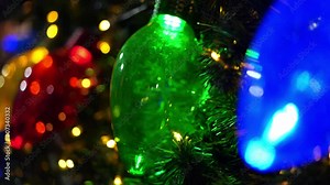 Big glitter bulb or lights colors bulbs on christmas tree. Christmas colorful glow lights on Xmas Tree. Video for Christmas Background.