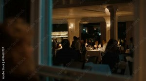 View Through a Window of a Busy Restaurant at Night