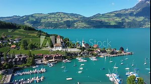 Aerial panoramic view of Spiez Church and Castle on the shore of Lake Thun in the Swiss canton of Bern at sunset, Spiez, Switzerland. Spiez Castle on lake Thun in the canton of Bern, Switzerland. Stock Video