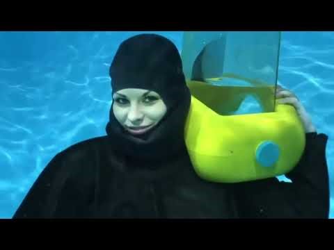 Female Diver is Diving with Rubber Drysuit and Scuba Helmet