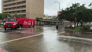 Galveston, TX, USA 6-19-2024: Coca-Cola Truck Drives Down Flooded Street on The Strand in Galveston, Texas During Tropical Storm Alberto
