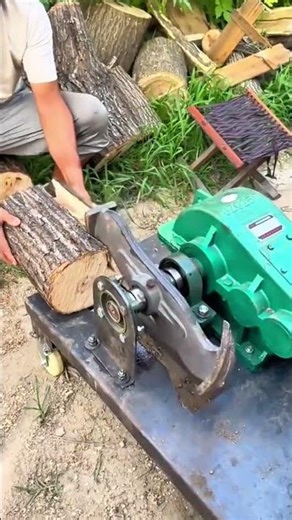 Splitting a large tree log into smaller pieces using a heavy electric wood splitter machine outdoors