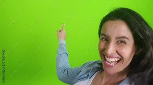 Cheerful young woman talking and looking at mobile cam talking laughing on green screen chroma key, happy female blogger speaking to video conference call online d