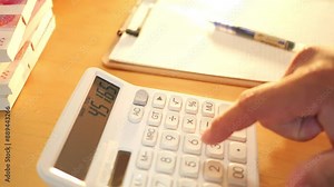 Accountant calculating with a calculator on a desk. Close up of an accountant hands calculating with a calculator on a desk,4k
