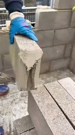 Applying Cement To Cinder Blocks For Stacking Wall Foundations In Modern Home Construction Projects