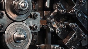 Manufacture of metal springs close-up. Commercial mass production at automatic conveyor process of factory line. Machinery manufacturing factory abstract concept processing. High tech technology