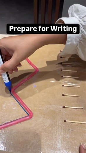By Shraddha ✨! Activities , Ideas , Gifts & DIY art for kids🌈 on Instagram: "✨DIY Pre-Writing Board for Toddlers ✨ I Made this super simple writing board using matchsticks, q-tips, and straws — all laminated with cellotape! I use a whiteboard marker to draw waves, zigzags, and loops around the shapes for engaging pre-writing practice. This activity helps toddlers: ✏️ Develop fine motor skills 🧠 Strengthen hand-eye coordination 🖐️ Build pencil control 👁️ Improve visual tracking 🎨 Encourage c