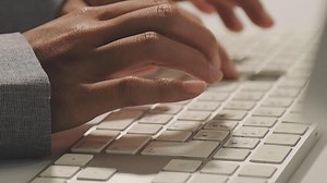 Download A person is typing on a computer keyboard for free