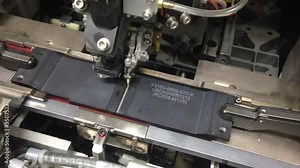 Industrial equipment for testing the quality of the assembly of microchip and electronic circuit board. Shot in motion, Camera Sensor for Mobile Phone Camera. Close up of the production of the sensors